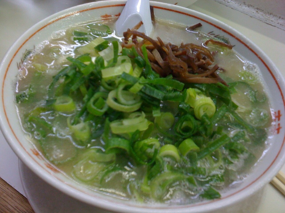 A bowl of Hakata ramen with cloudy pork bone broth, thin noodles and chashu