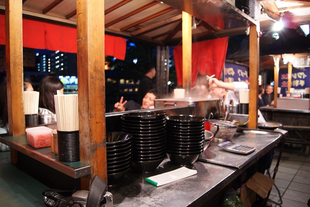Yatai beside the Naka River, with yakitori and ramen signs side by side