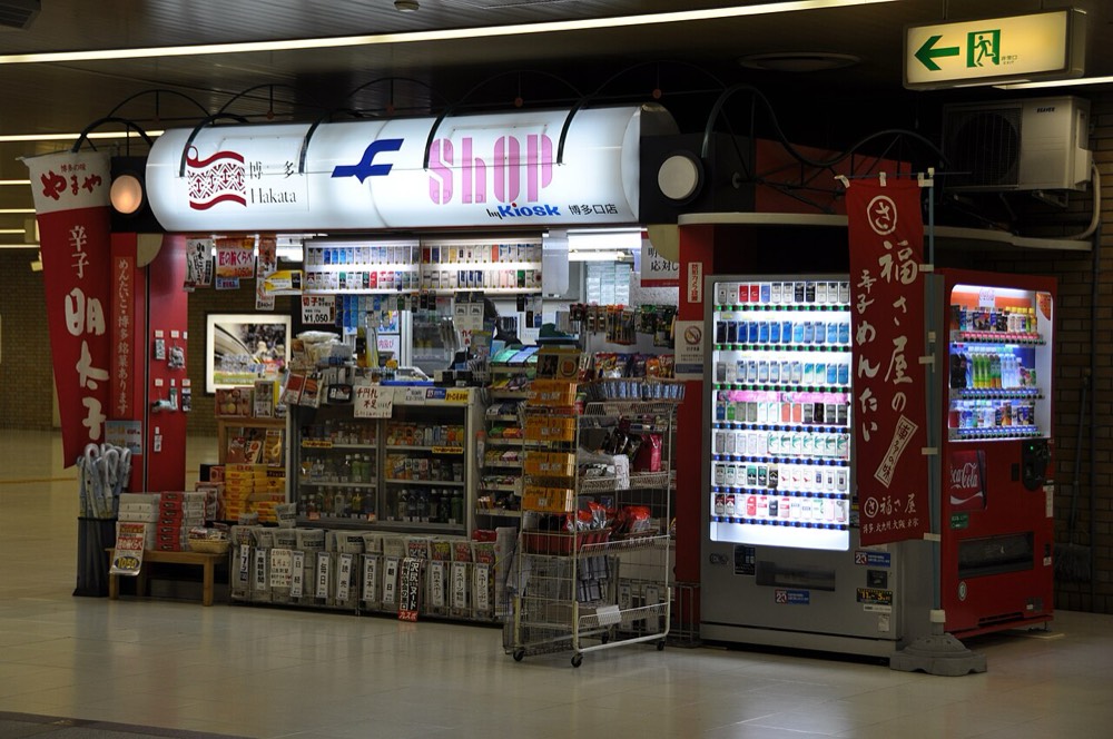 A mentaiko shop kiosk inside a station, with a sign reading karashi mentaiko
