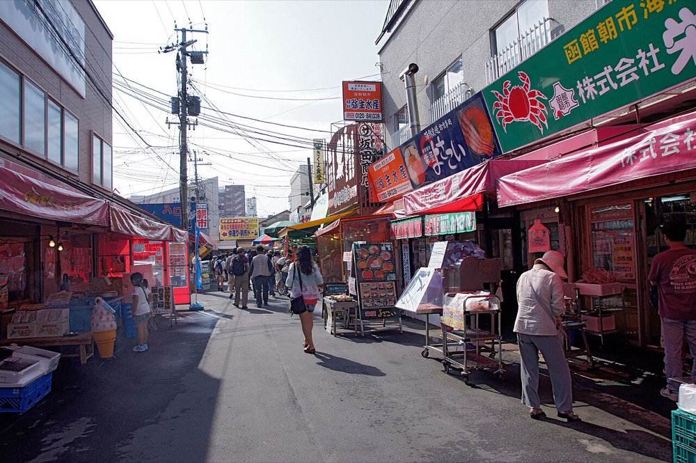 A street in the Hakodate Morning Market, lined with seafood shops with crab signs