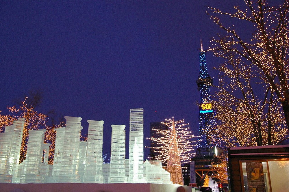 Ice sculptures and lights in Sapporo at night, with the TV Tower in the distance
