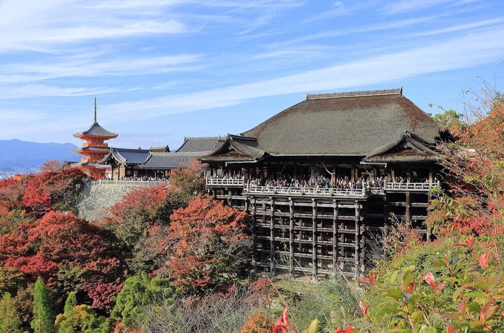 Kiyomizu-dera in autumn, with the wooden stage and surrounding red trees