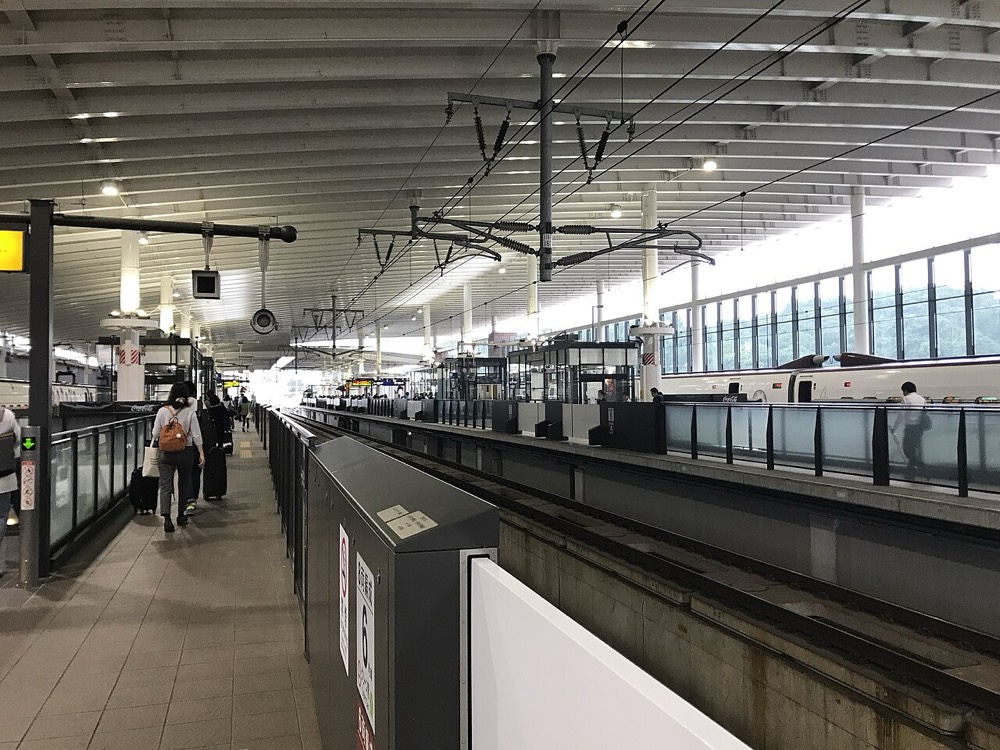 The Kyushu Shinkansen platform at Kumamoto Station, with the tracks stretching into the distance