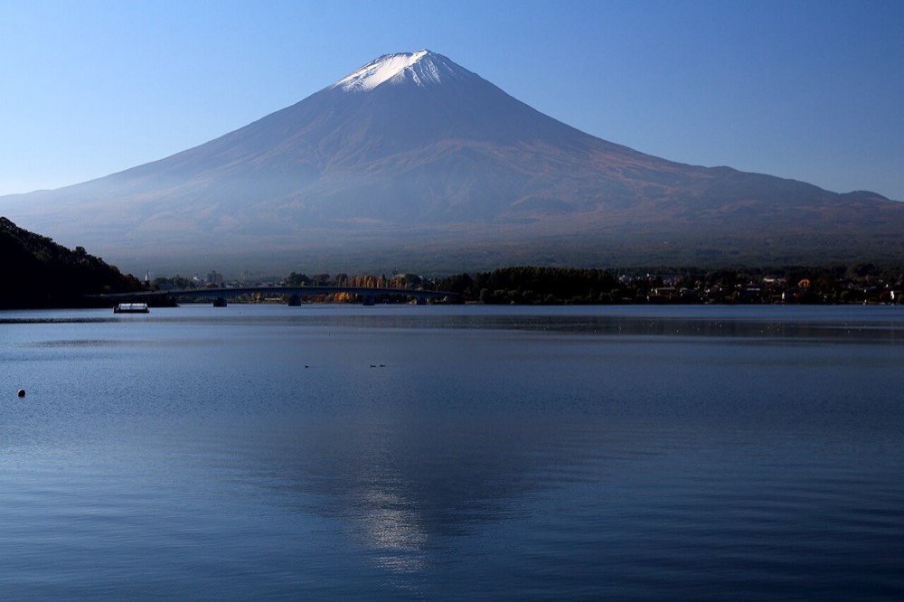 Mt. Fuji seen in the distance from the shore of Lake Kawaguchiko