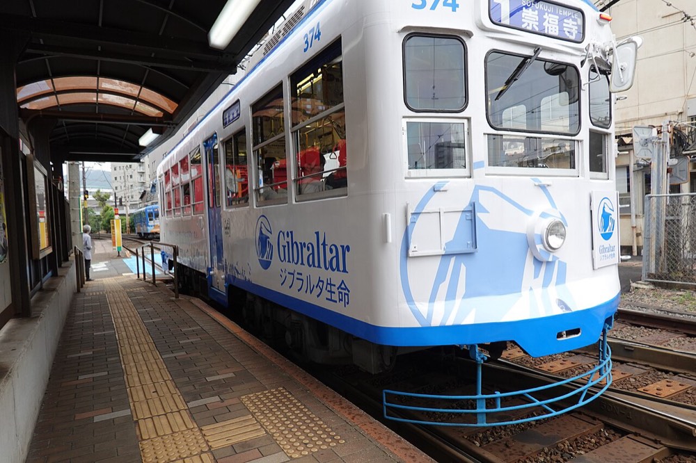 A Nagasaki tram stopped at a platform