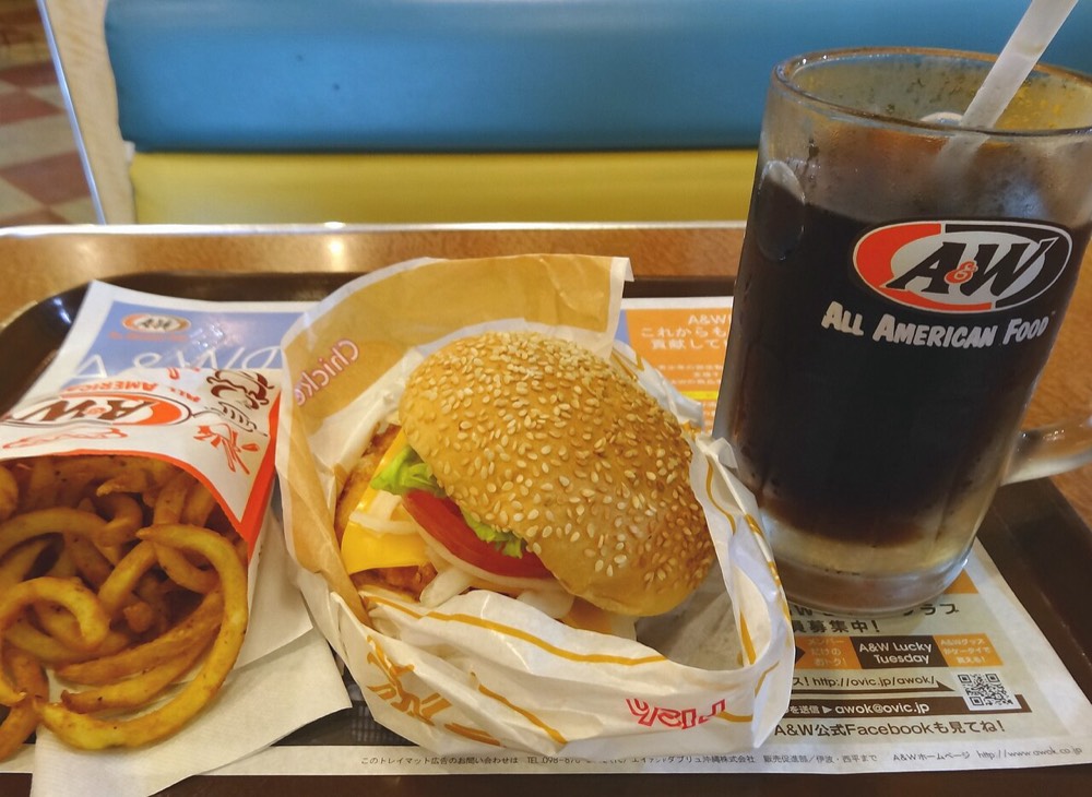 An A&W chicken burger, curly fries and root beer on a tray, common in Okinawa