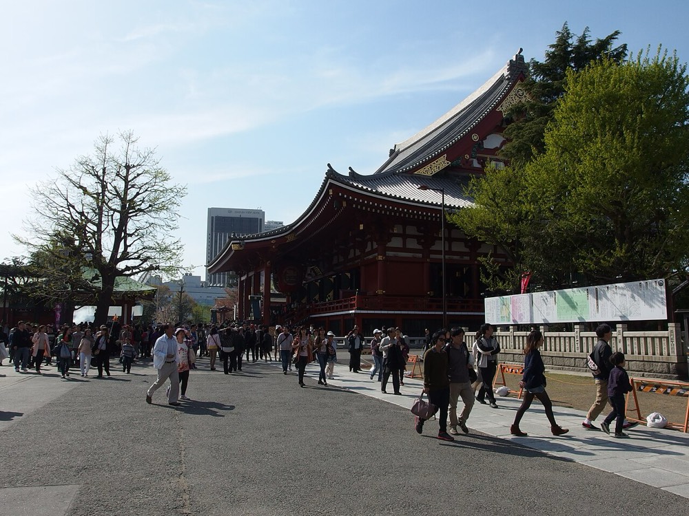 The red halls inside Senso-ji grounds with visitors passing by